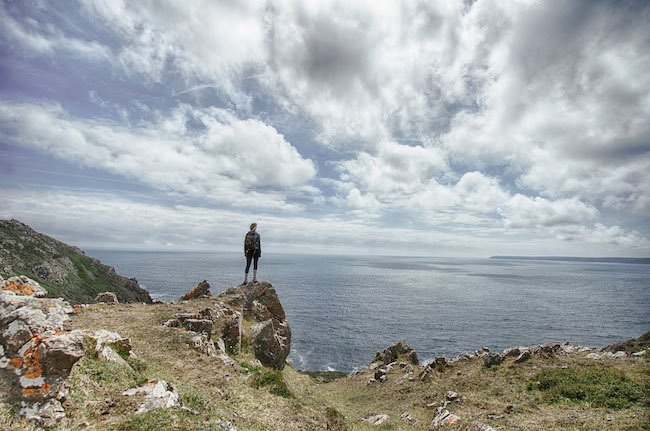 man standing looking at the ocean; the acronym O.C.E.A.N. can help identify safety leader traits
